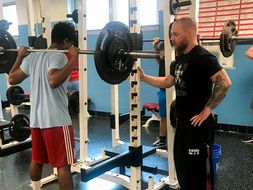 Ryan Wood teaching a student to dead-lift.