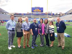 CPASS faculty standing on mountaineer field after being recognized