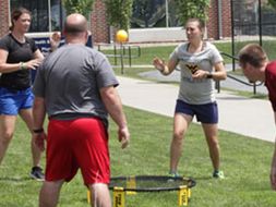 Katie tossing a ball with other students