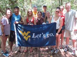 Students in Costa Rica holding a WVU Flag
