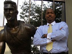 Autry Parker Brantley with Jerry West statue in front of WVU Coliseum 