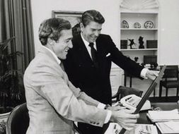 Robert Deprospero and Ronald Reagan looking at a photograph