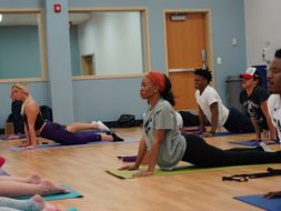 Students practice Yoga in CPASS fitness instruction room.