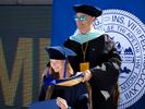 Professor Sam Zizzi awards Erika Van Dyke her sash for completing her PhD