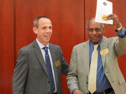 Photo of Dr. Jack Watson and Dean Dana Brooks presenting awards.