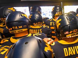 WVU football players are in the tunnel, shown ready to enter the field.